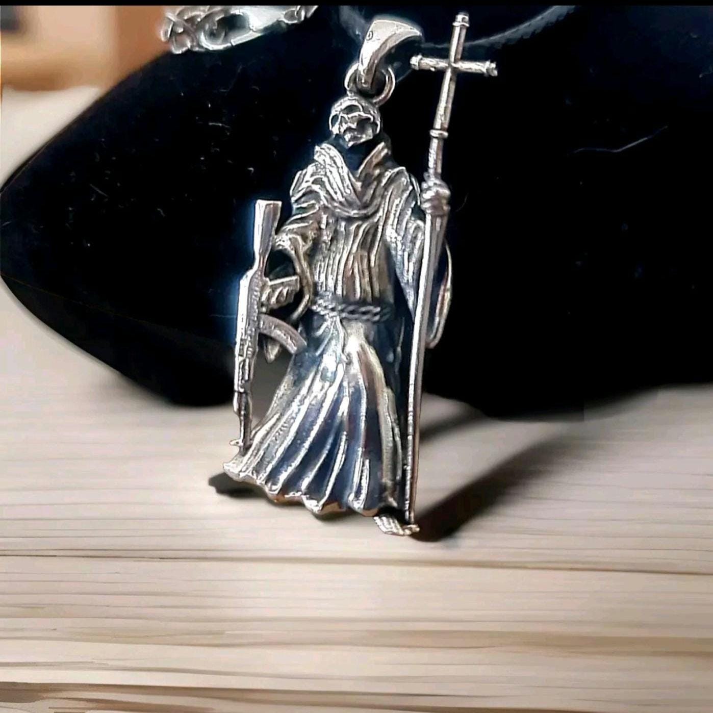 La Santa Muerte 925 Sterling Silver pendant holding a Cross and a Gun - 5CM ( 2 INCHES )