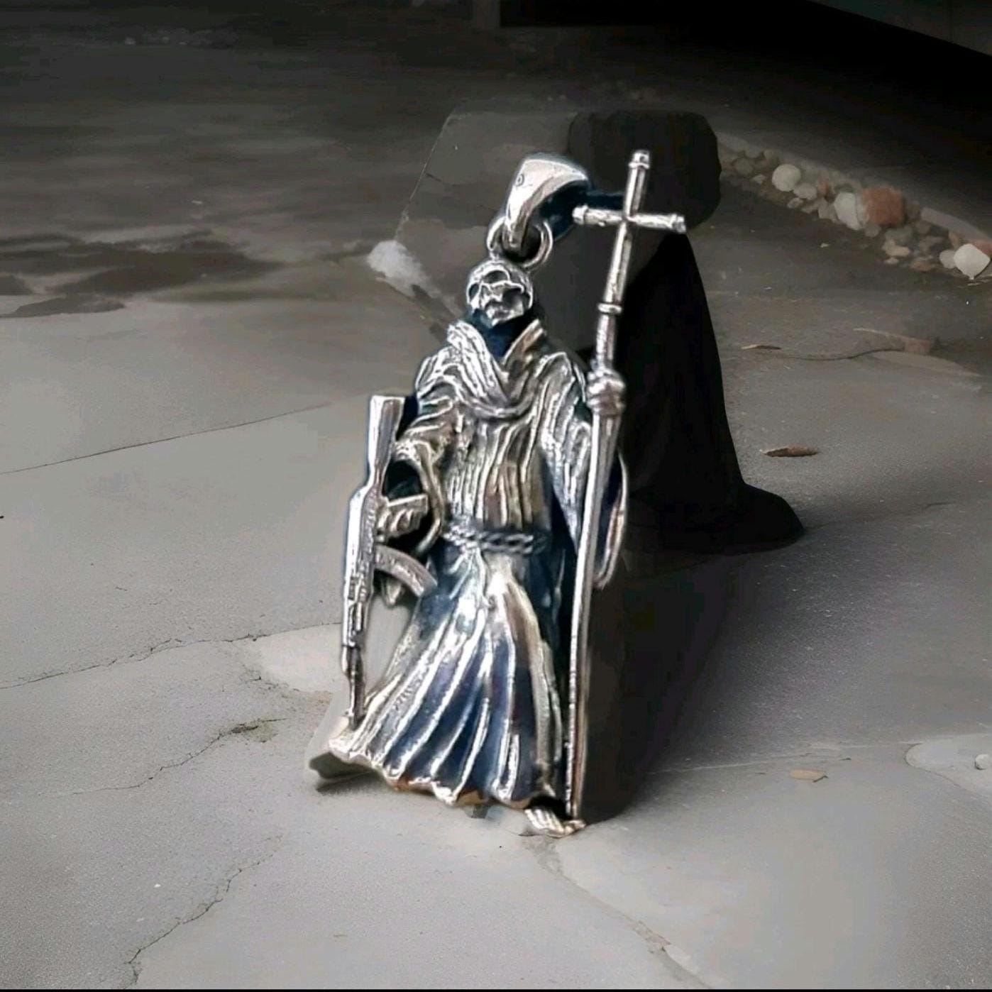 La Santa Muerte 925 Sterling Silver pendant holding a Cross and a Gun - 5CM ( 2 INCHES )